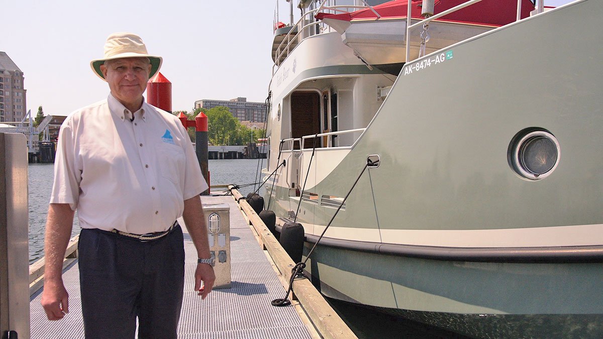 photo of Richard Evans next to boat